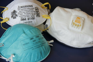 three niosh n95 masks laying on table