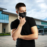 man standing in front of office building and wearing a black lg kf94 mask